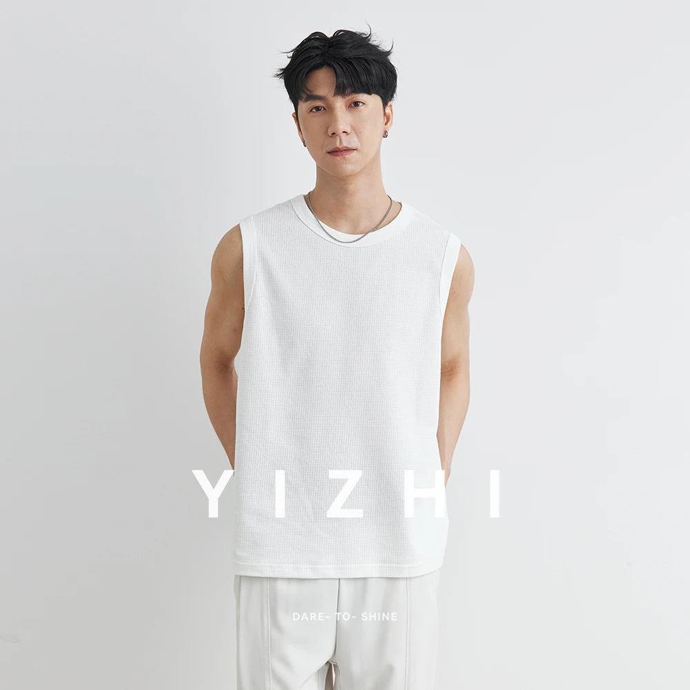 Person wearing a white sleeveless shirt with 'YIZHI' branding on a light gray background