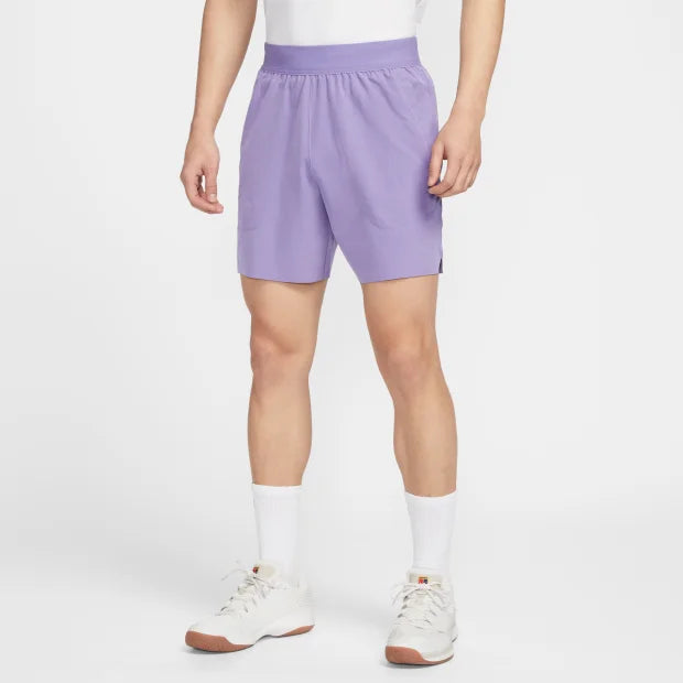Person wearing lavender shorts on a white background